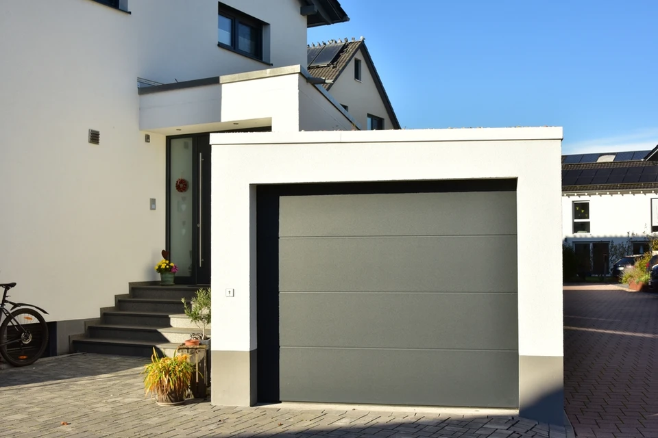 Entrée résidentielle extérieure avec portail métallique vert à double vantaux et motifs ornementaux